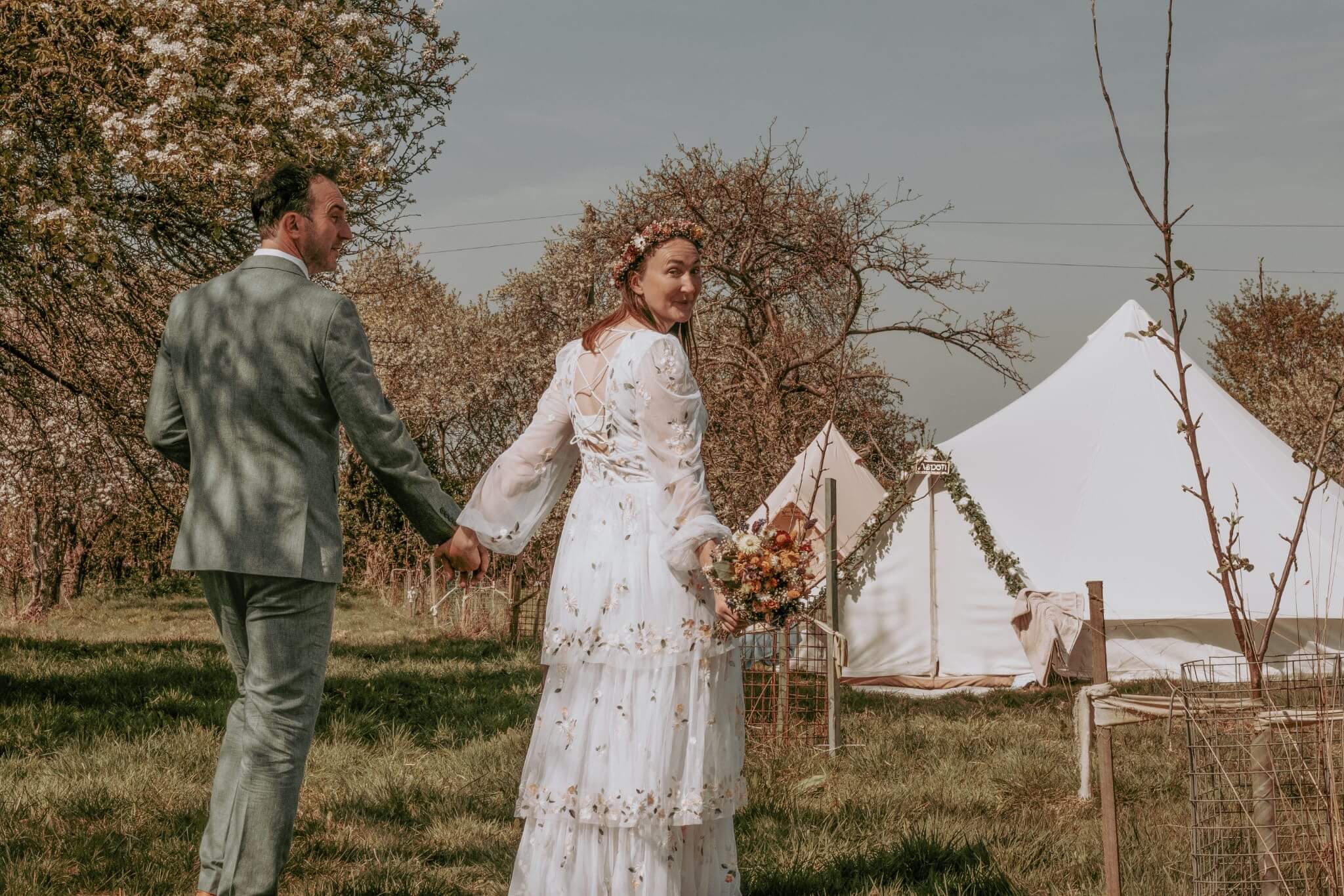 Bride and groom with their wedding glamping tents
